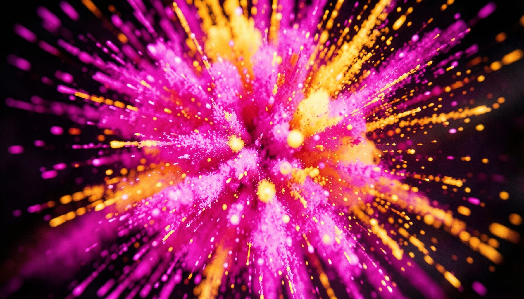 Dynamic particle explosion in vivid magenta, orange, and yellow tones bursting outward, cinematic shallow depth of field